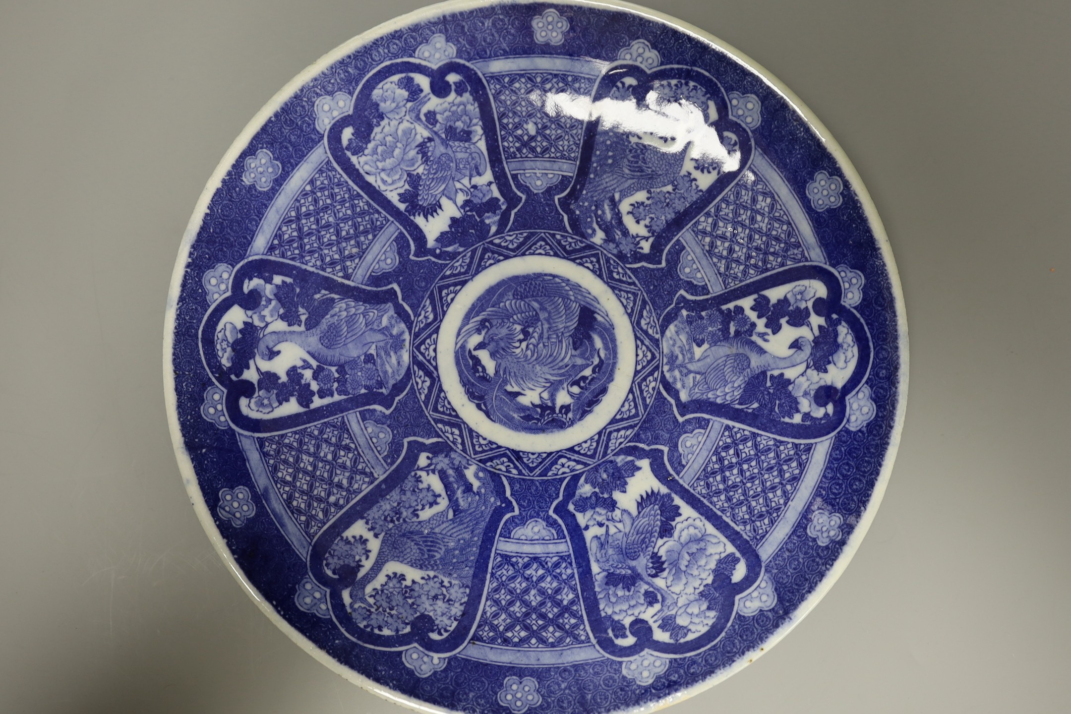 Five early 20th century Japanese blue and white dishes, largest 30.5cm diameter